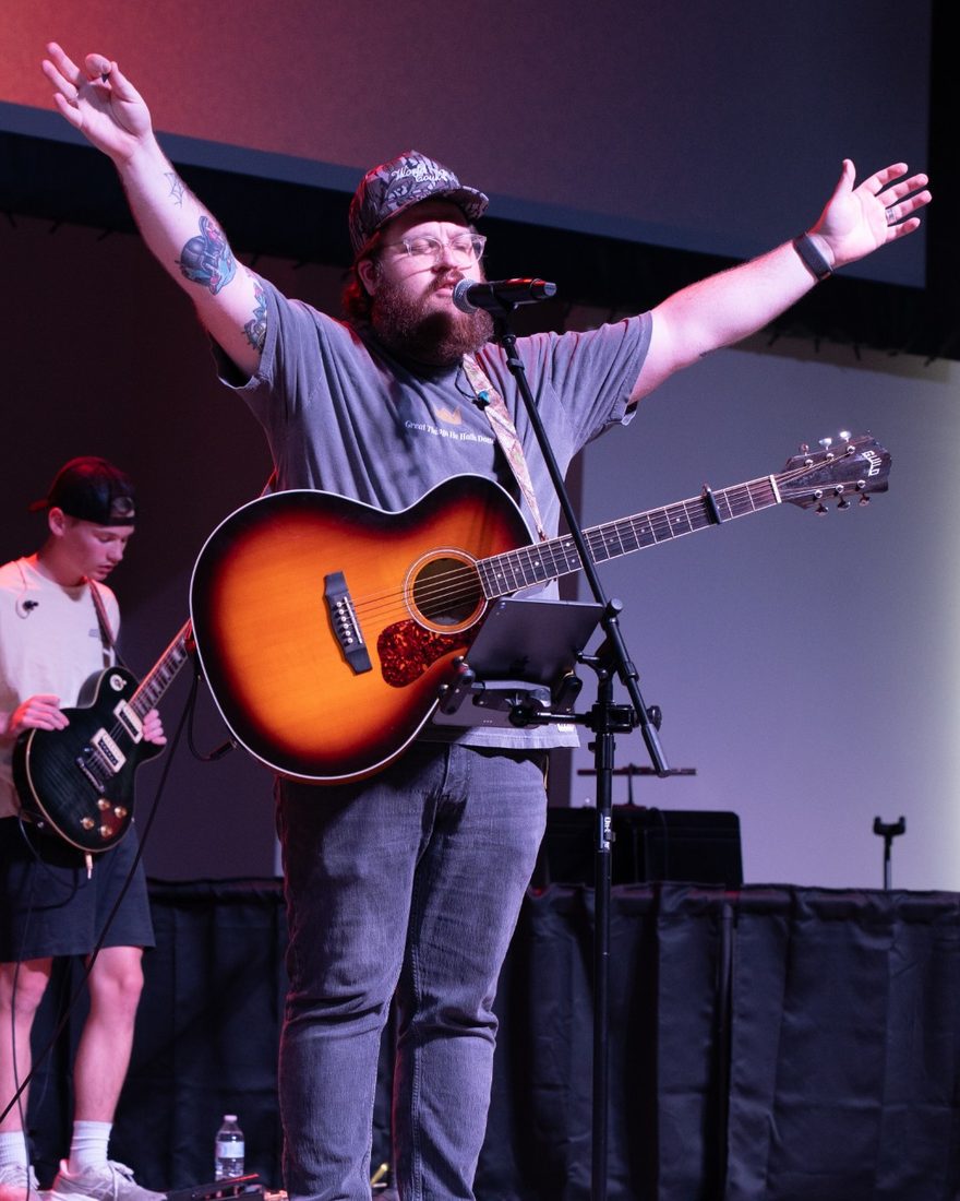 Sam leading worship on acoustic guitar